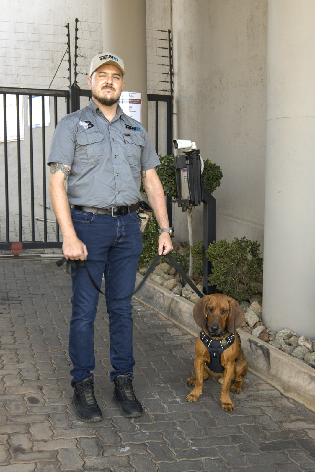 TEN8 officer with K9 unit at estate access control point