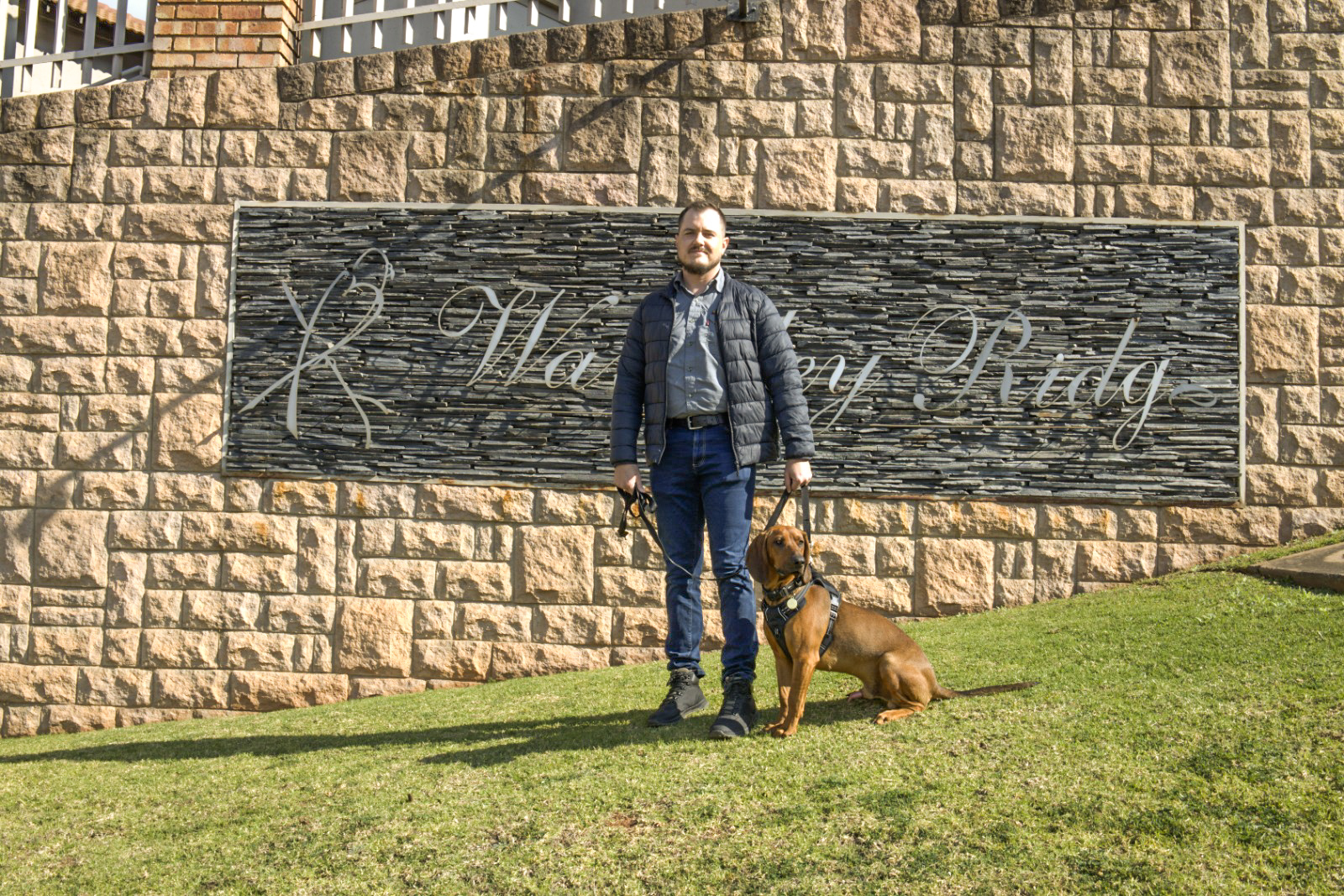 TEN8 K9 handler with detection dog at estate boom gate