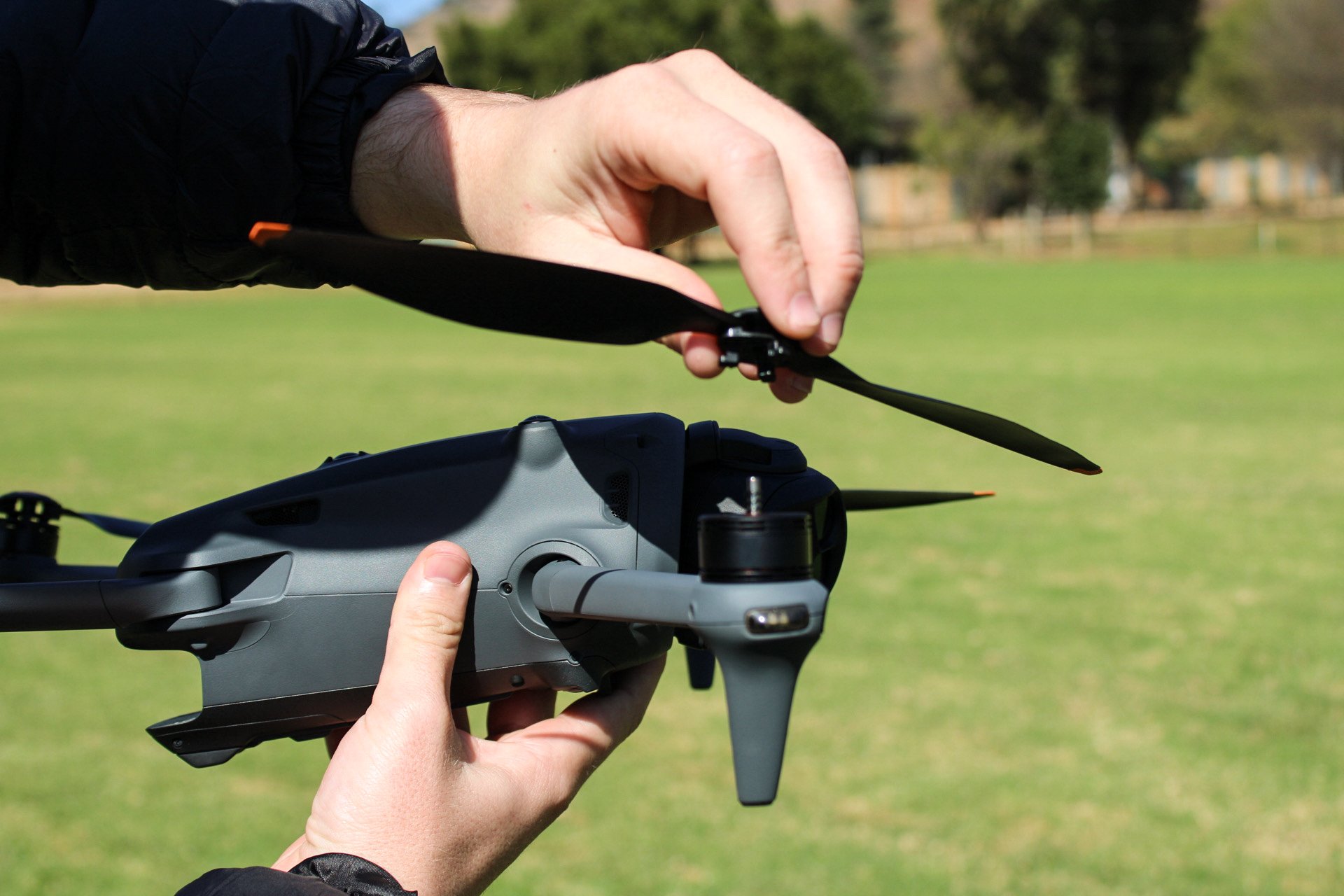 TEN8 pilot fitting a propeller to a drone during pre-flight preparation