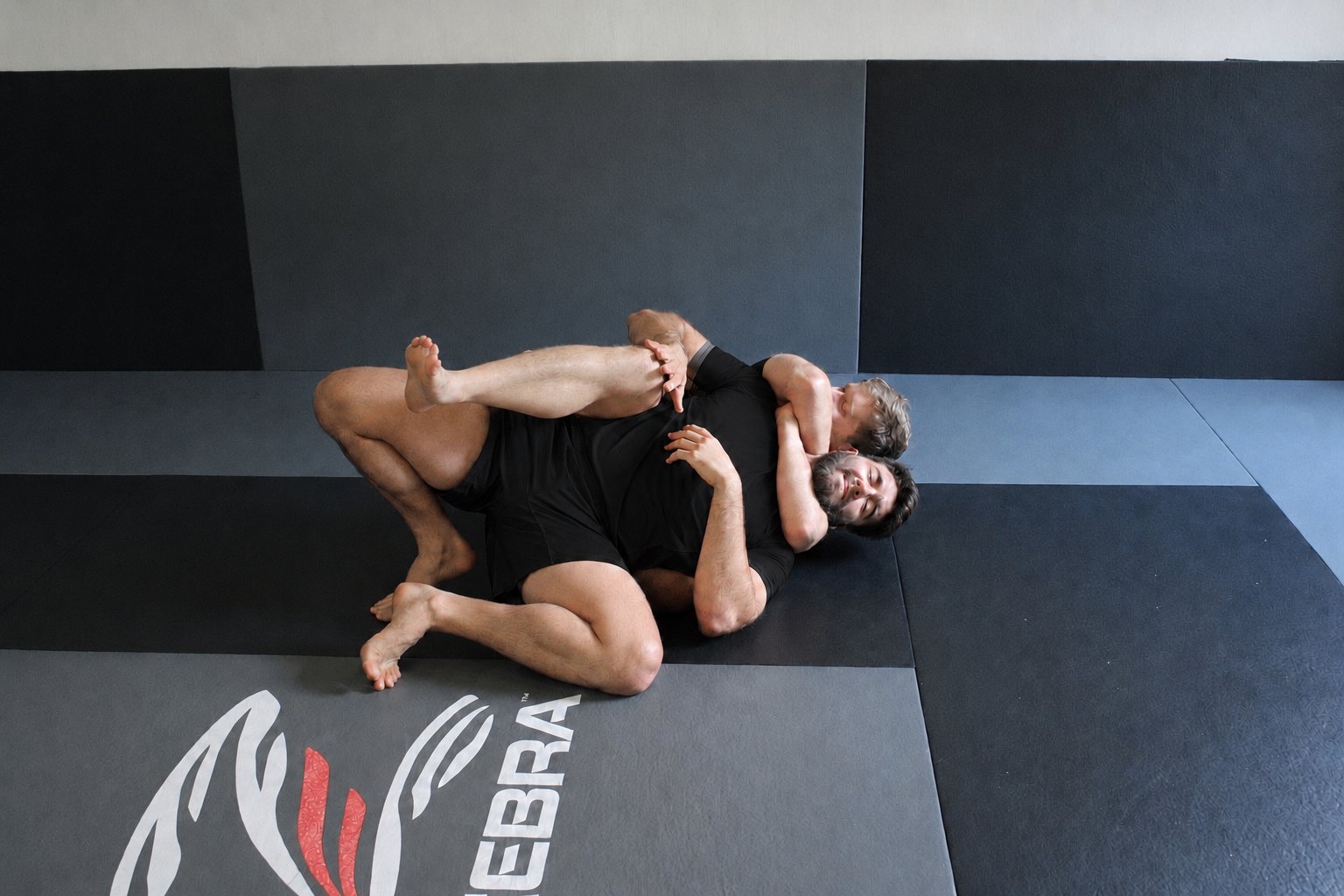 TEN8 operators drilling a ground control and submission technique on the mat